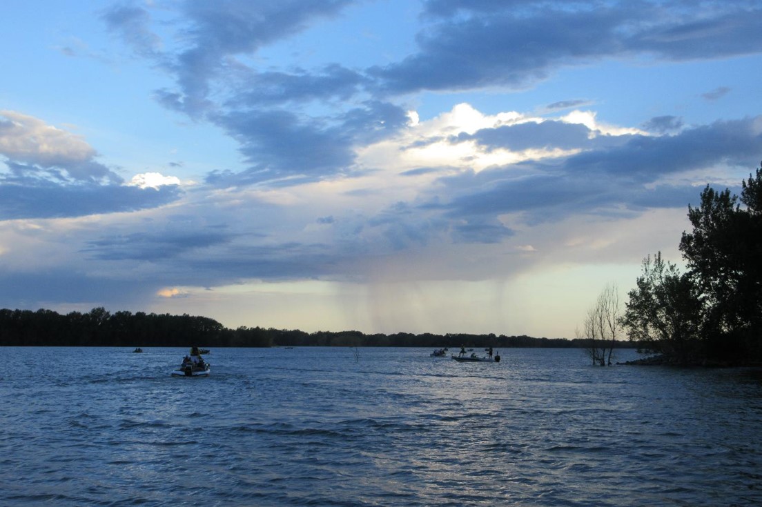 Early morning fishing boats on a reservoir.