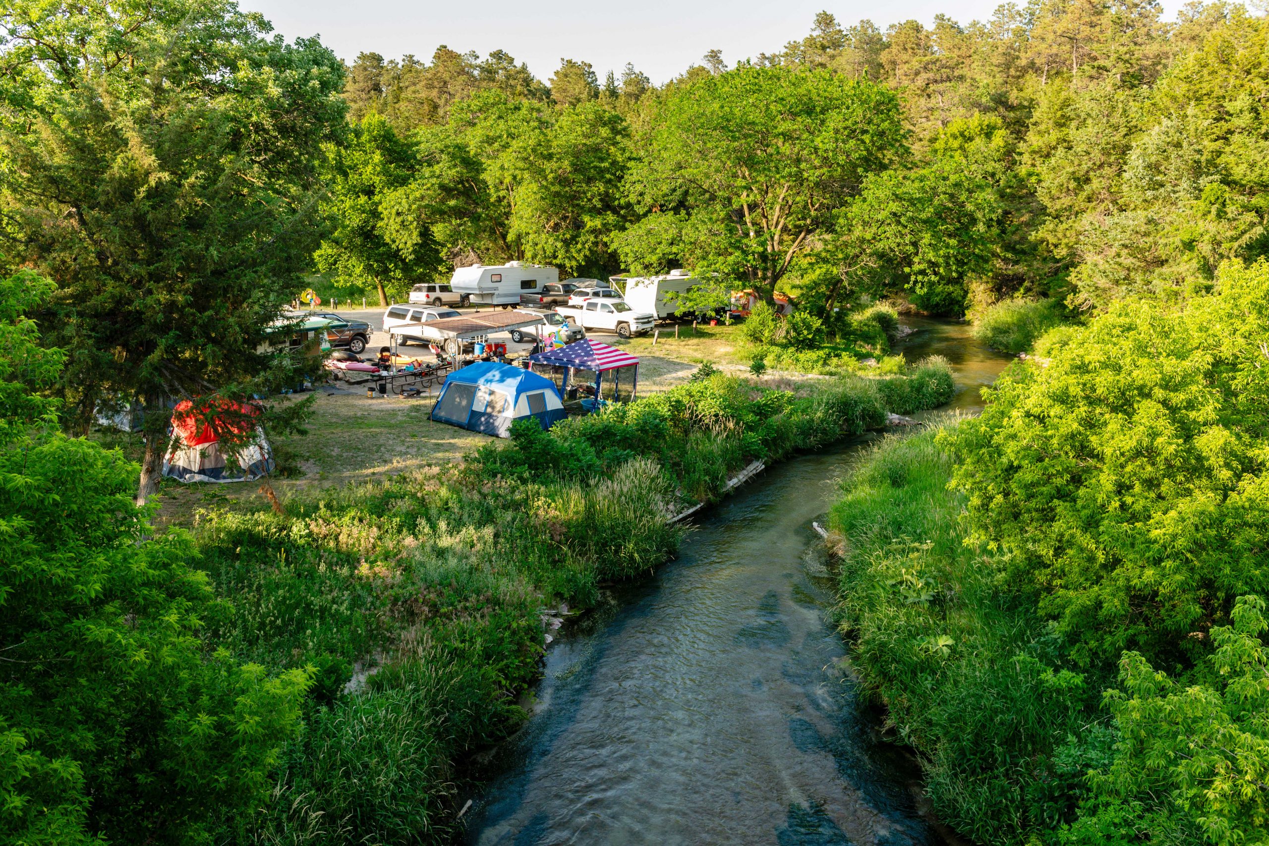 Families enjoying camping along Long Pine Creek at Long Pine State Recreation Area in Brown County.
