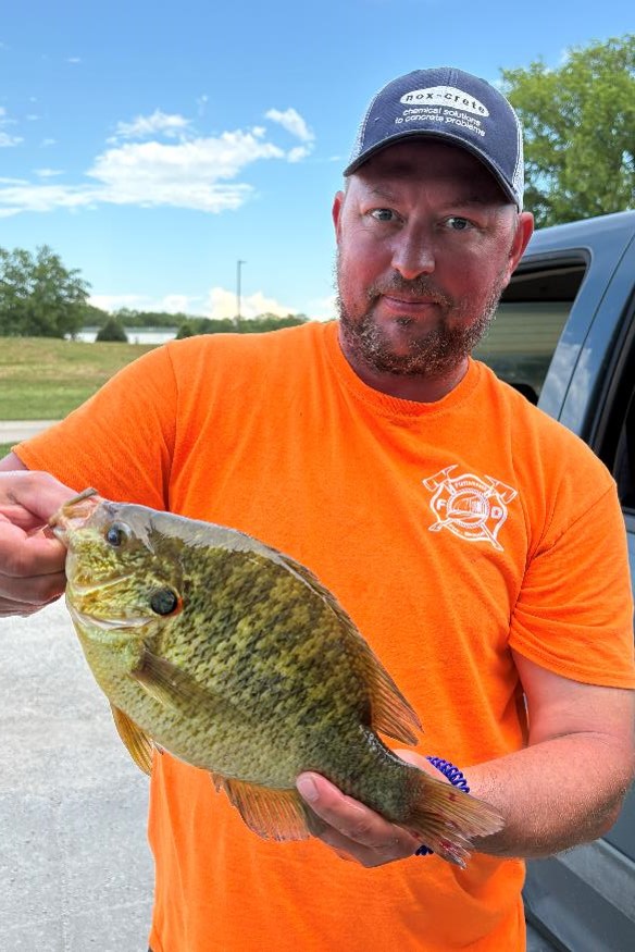 Angler holding redear sunfish.  Nebraska Game & Parks Commission photo.