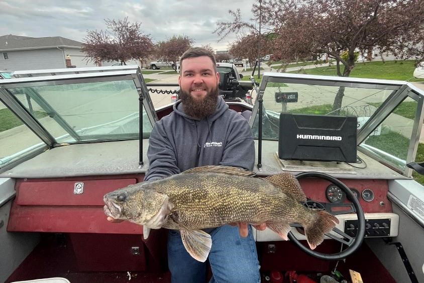 Angler in boat holding saugeye.  Nebraska Game & Parks Commission photo.