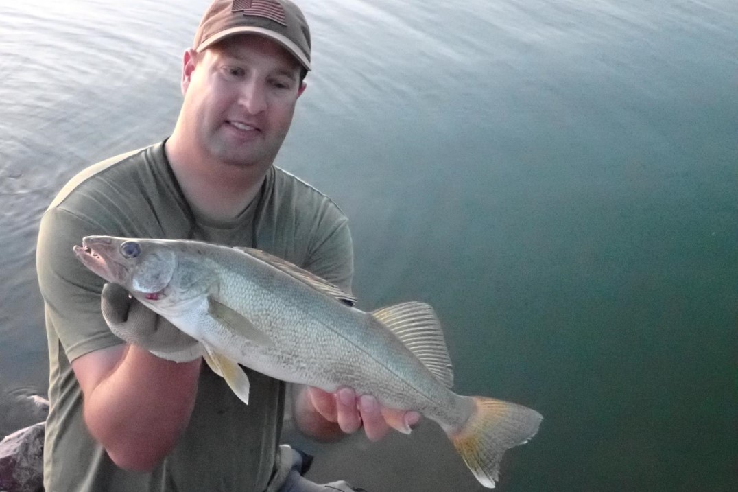 Angler holding a walleye.  Photo by Daryl Bauer, Nebraska Game & Parks Commission.