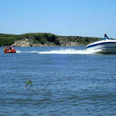 Boat pulling a tube. Photo by Daryl Bauer, Nebraska Game & Parks Commission.