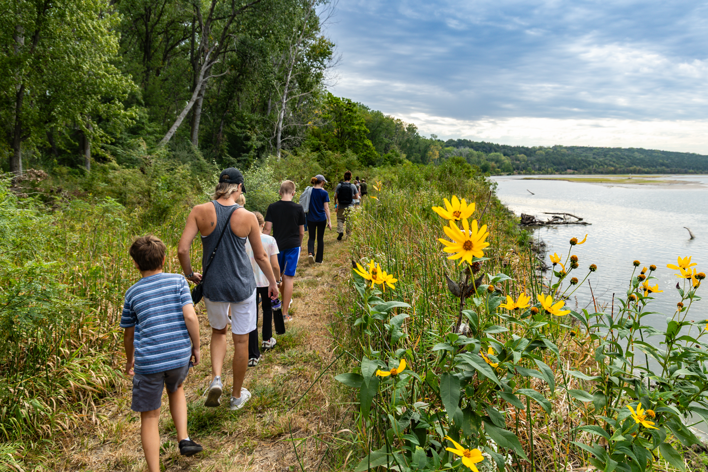 Families hike on a trail following the Platte River at Schramm Park State Recreation Area.
