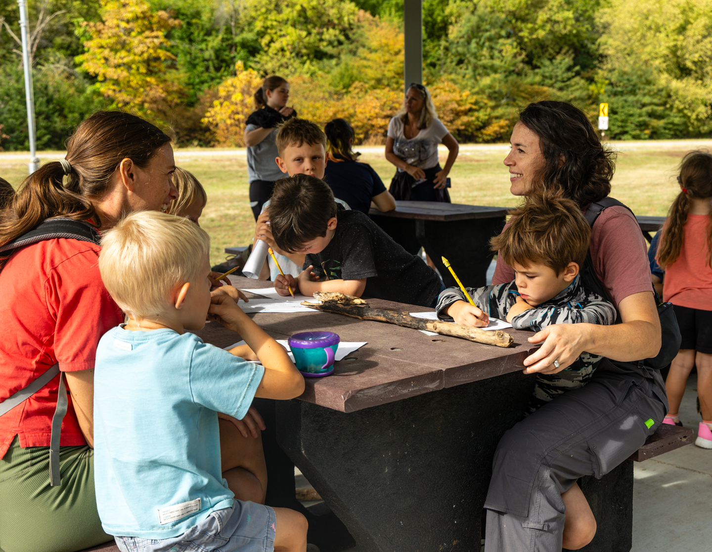 Janna O’Mally of Omaha, left, and Katelynn Moore of Seward learn with their children during a Homeschool Hike program.
