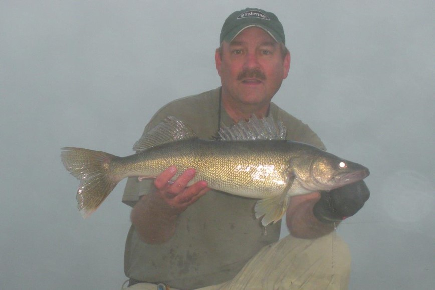Angler holding walleye. Photo by Daryl Bauer, Nebraska Game & Parks Commission.