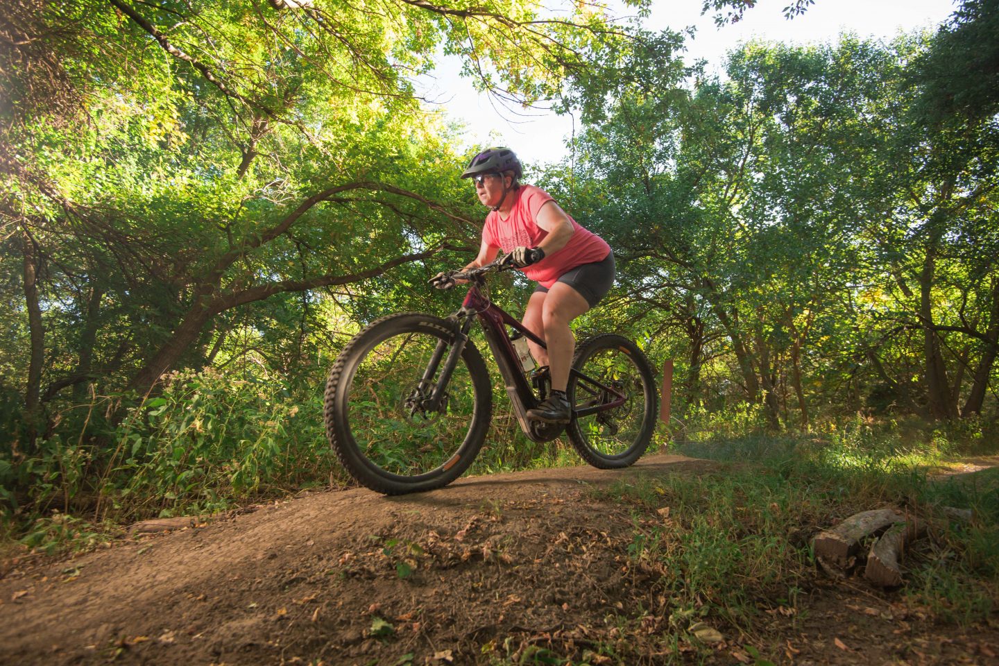 A woman riding the mountain biking course at Branched Oak SRA.