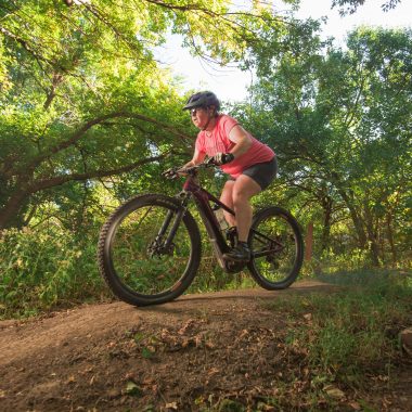 A woman riding the mountain biking course at Branched Oak SRA.