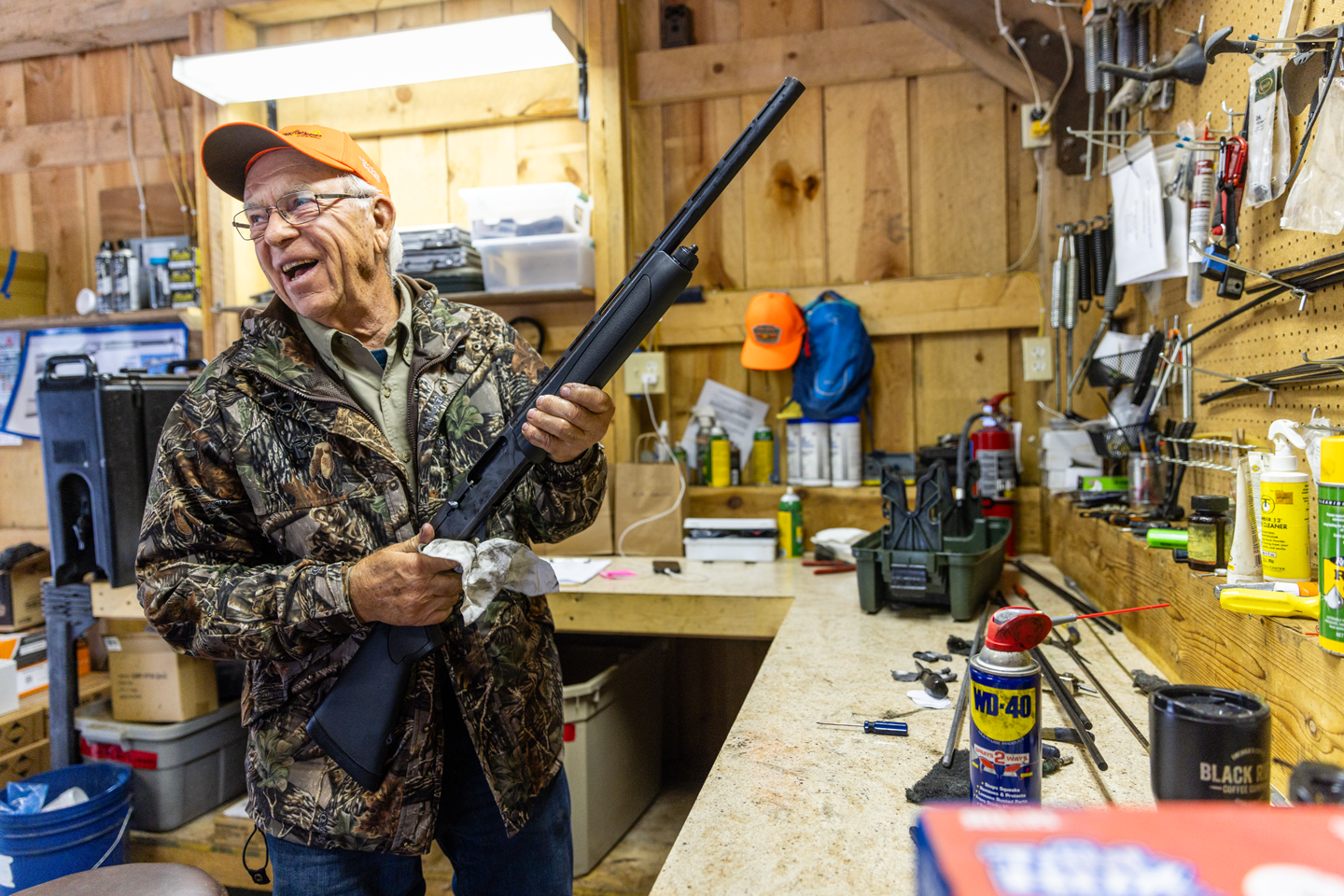 Volunteer Don Andersen cleans shotguns at the shooter’s village.