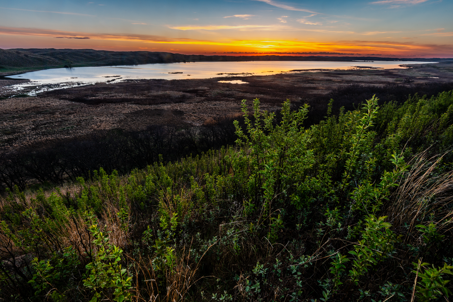 The sun rises behind Steverson Lake, which has the most surface area of the property’s three lakes.