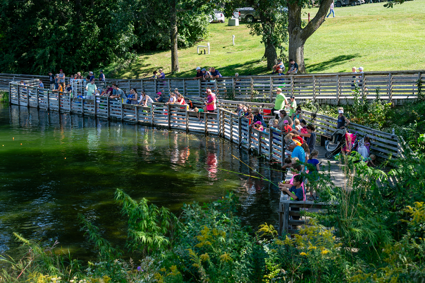Children and parents fishing at Ponca State Park’s pond.
