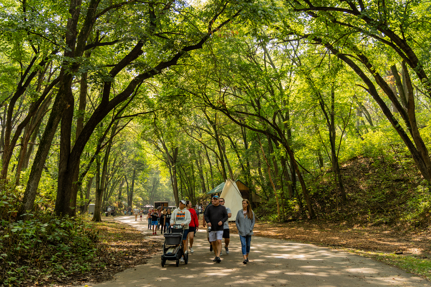 A family walks down the path that leads through the Eric Wiebe Shooting Complex.