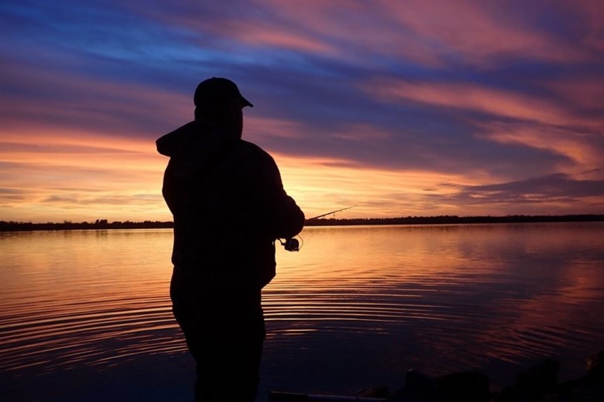 Wading angler at sunset.  Photo by Daryl Bauer, Nebraska Game & Parks Commission.