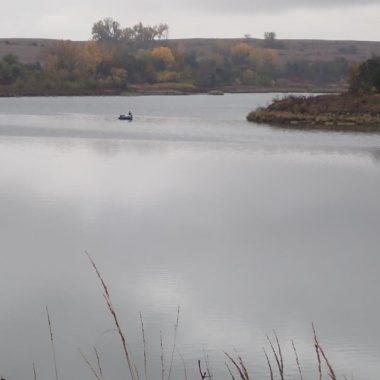 Boat angler on fall lake. Photo by Daryl Bauer, Nebraska Game & Parks Commission.