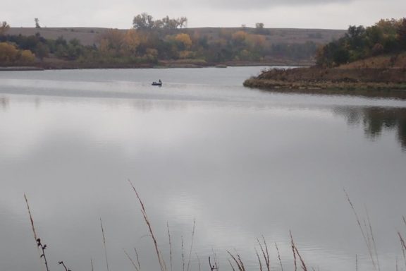 Boat angler on fall lake. Photo by Daryl Bauer, Nebraska Game & Parks Commission.