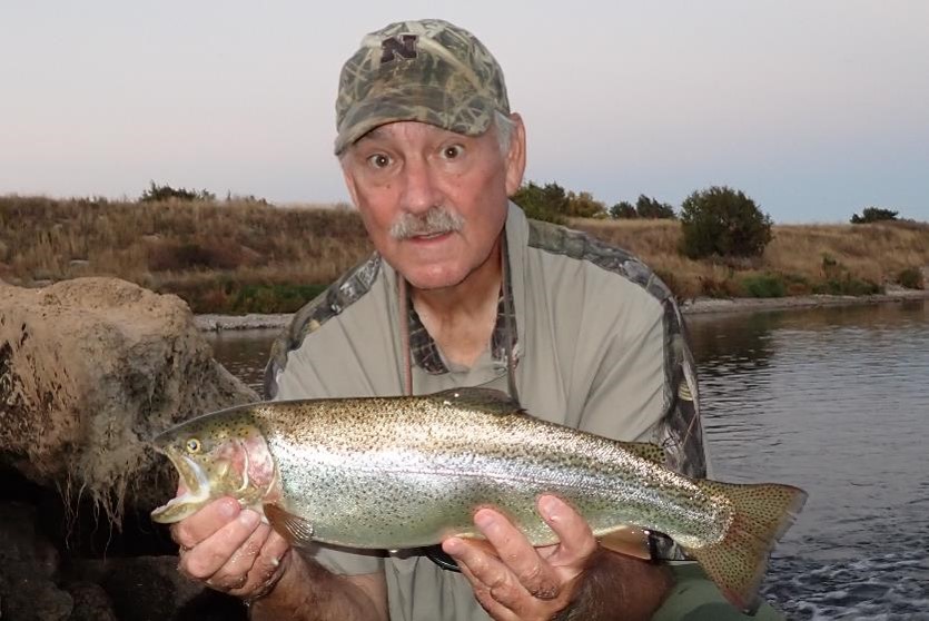 Angler holding a cutbow trout.  Photo by Daryl Bauer, Nebraska Game & Parks Commission.