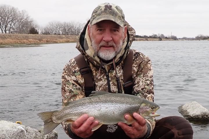 Angler holding cutbow trout.  Photo by Daryl Bauer, Nebraska Game & Parks Commission.
