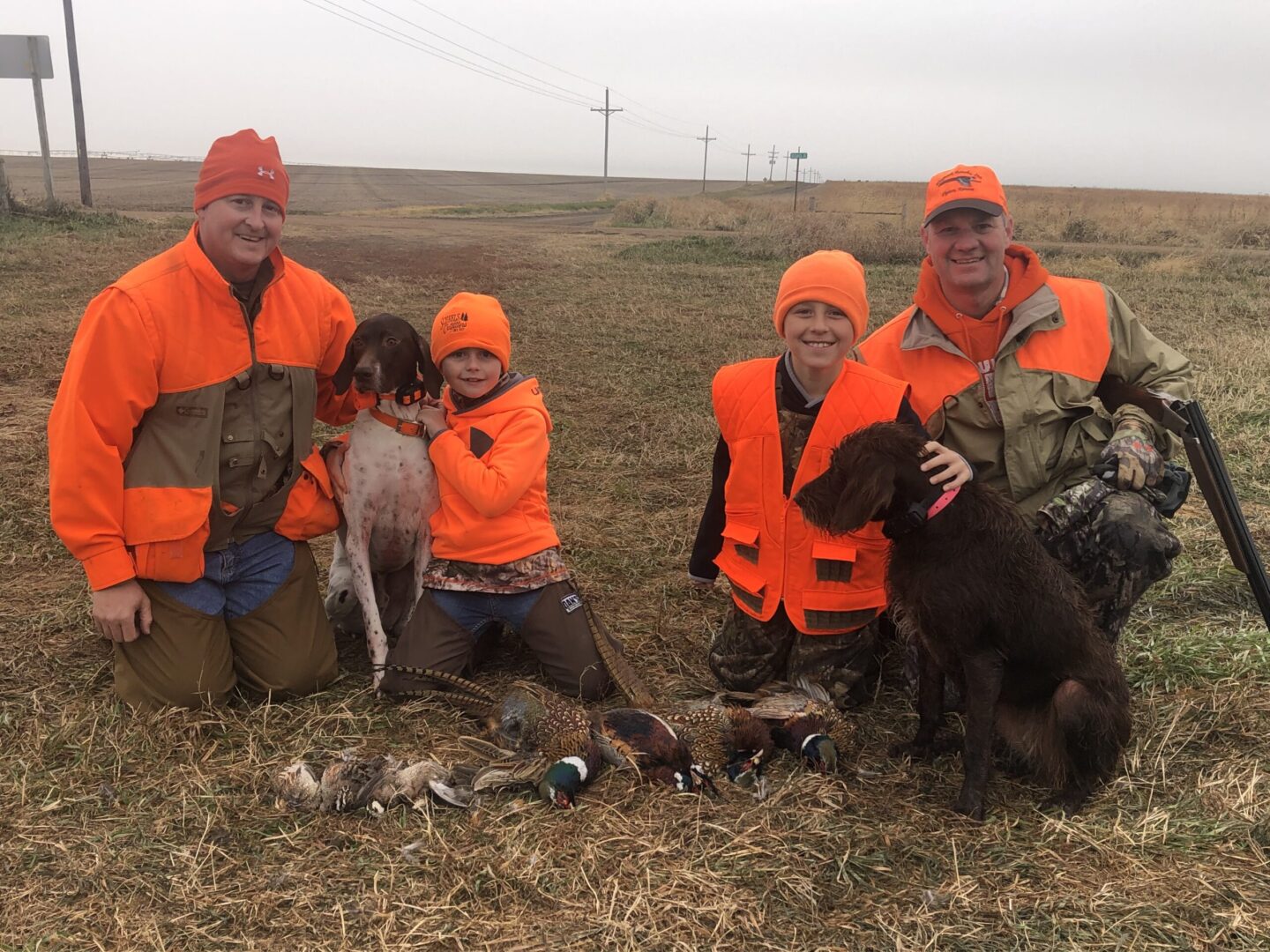 Justin Stofer, his German shorthair, Mojo, son Teegan, Soren Frahm, pudelpointer Penny and Shane Frahm after a day of hunting in Saline, Thayer and Fillmore counties. Photo courtesy of Justin Stofer.