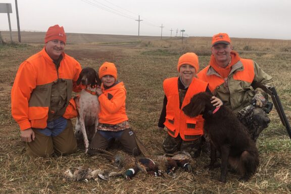 Justin Stofer, his German shorthair, Mojo, son Teegan, Soren Frahm, pudelpointer Penny and Shane Frahm after a day of hunting in Saline, Thayer and Fillmore counties. Photo courtesy of Justin Stofer.