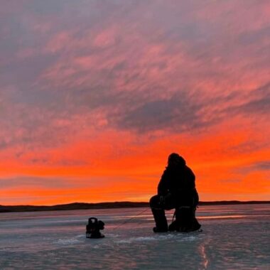 Ice angler silhouetted in sunset. Photo by Daniel Bauer.