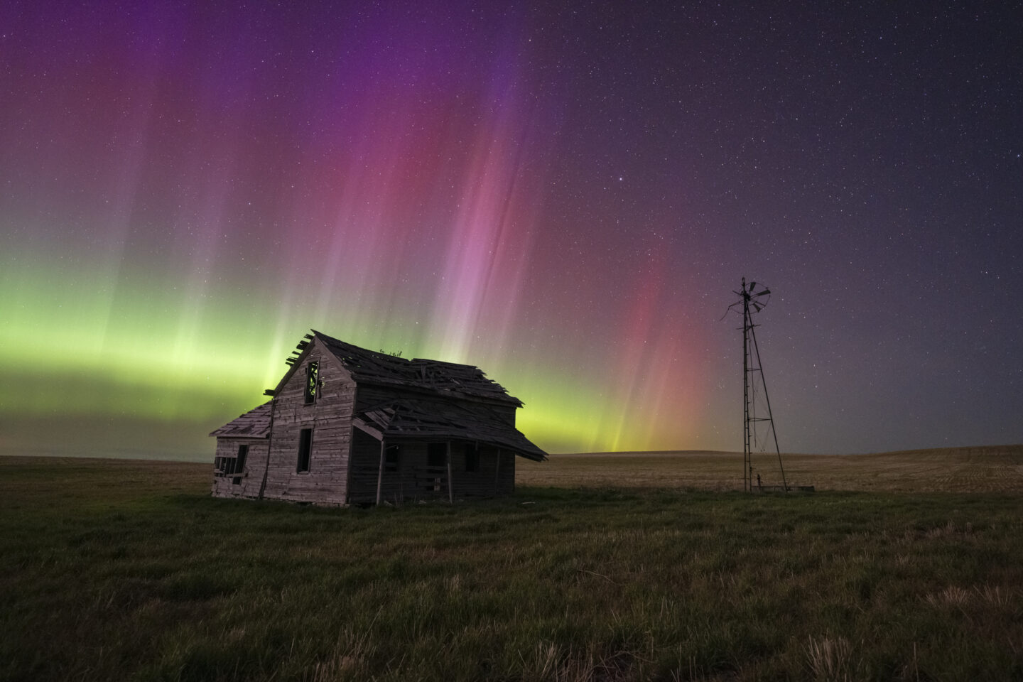 An old home near Crawford under a vibrant curtain of light. The KP index on this night reached 9 and is considered to be the strongest solar storm on Earth in the last two decades.