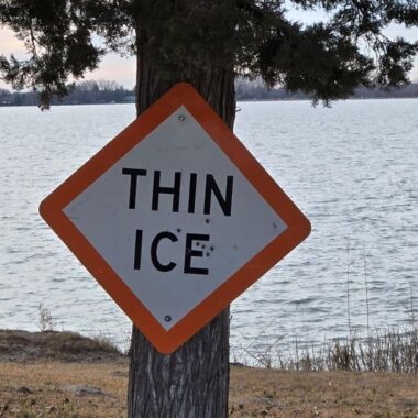 Thin Ice sign on lake shore. Photo by Daryl Bauer, Nebraska Game & Parks Commission.