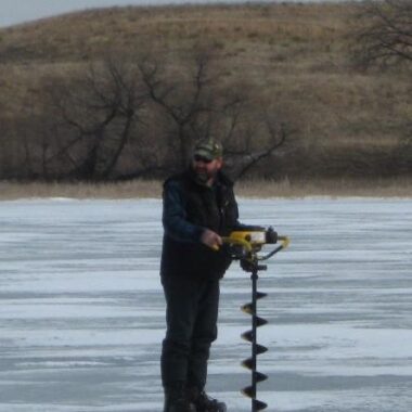Angler drilling hole in ice. Don Cox photo.