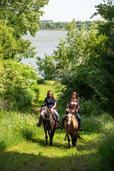 Kenzie and Brianna Kesselring of Garland ride their horses down a trail in Area 2.