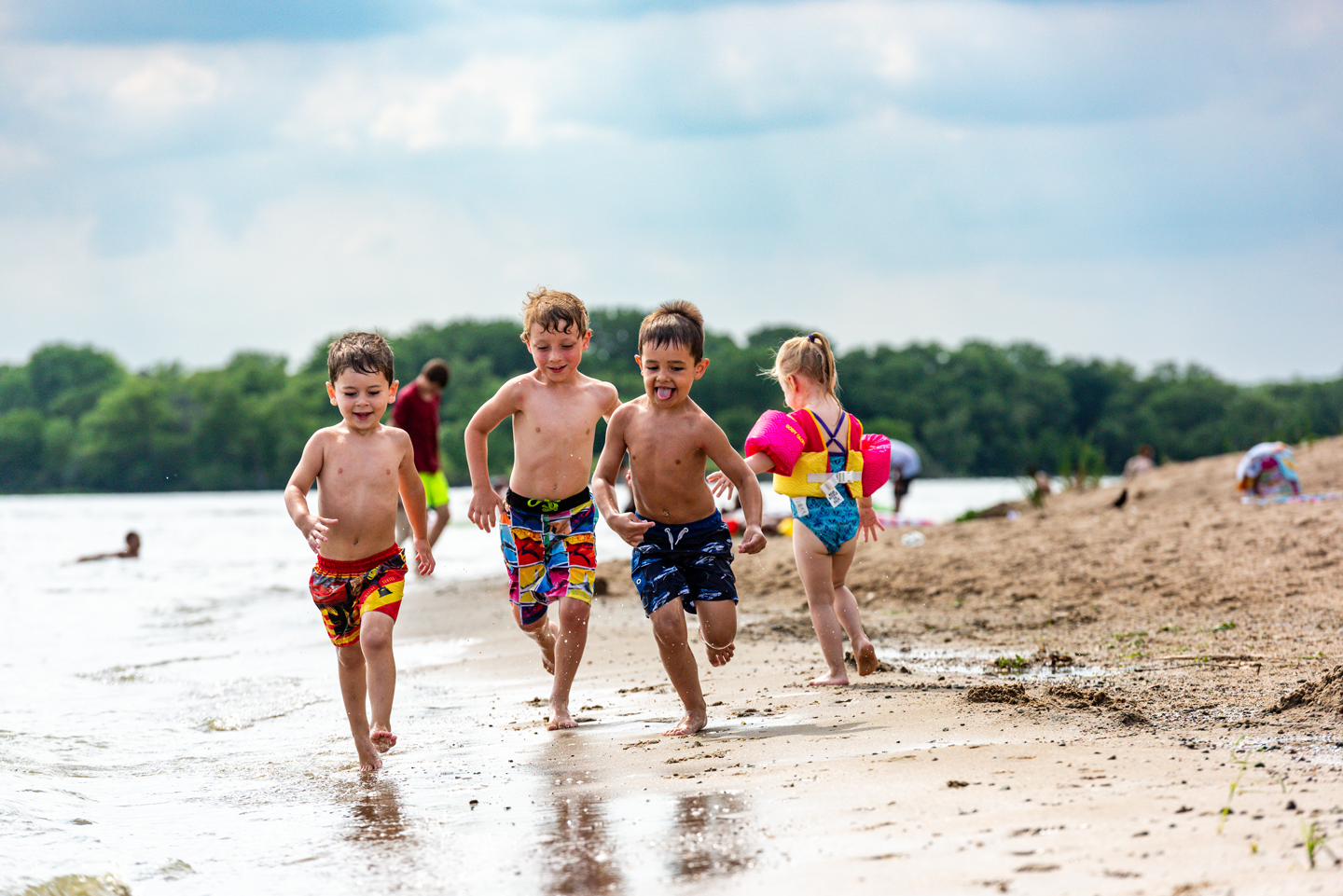 Jonah Phillip, Foster Pierce and Jaydon Phillip of Lincoln play on the swim beach in Area 1.
