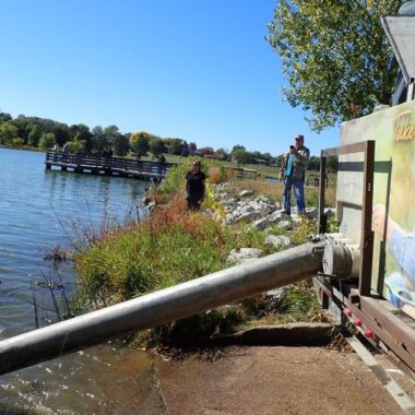 Stocking truck releasing fish through a pipe. Daryl Bauer photo, Nebraska Game & Parks Commission.