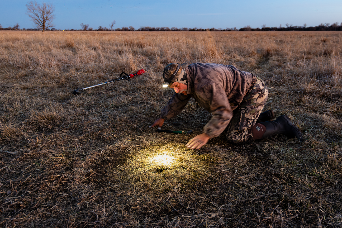Dave Brandt, a retired U.S. Geological Survey biologist, sets a radio triggered snare he designed and built in hopes of capturing a sandhill crane to tag last spring as part of a research project led by the Crane Trust.