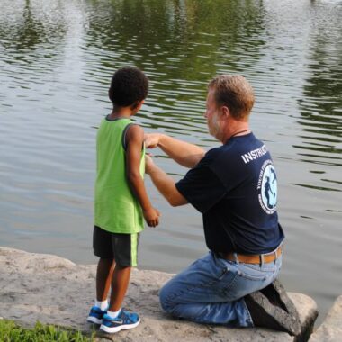Nebraska Youth Fishing Instructor assisting a young angler. Photo by Nebraska Game & Parks Commission.