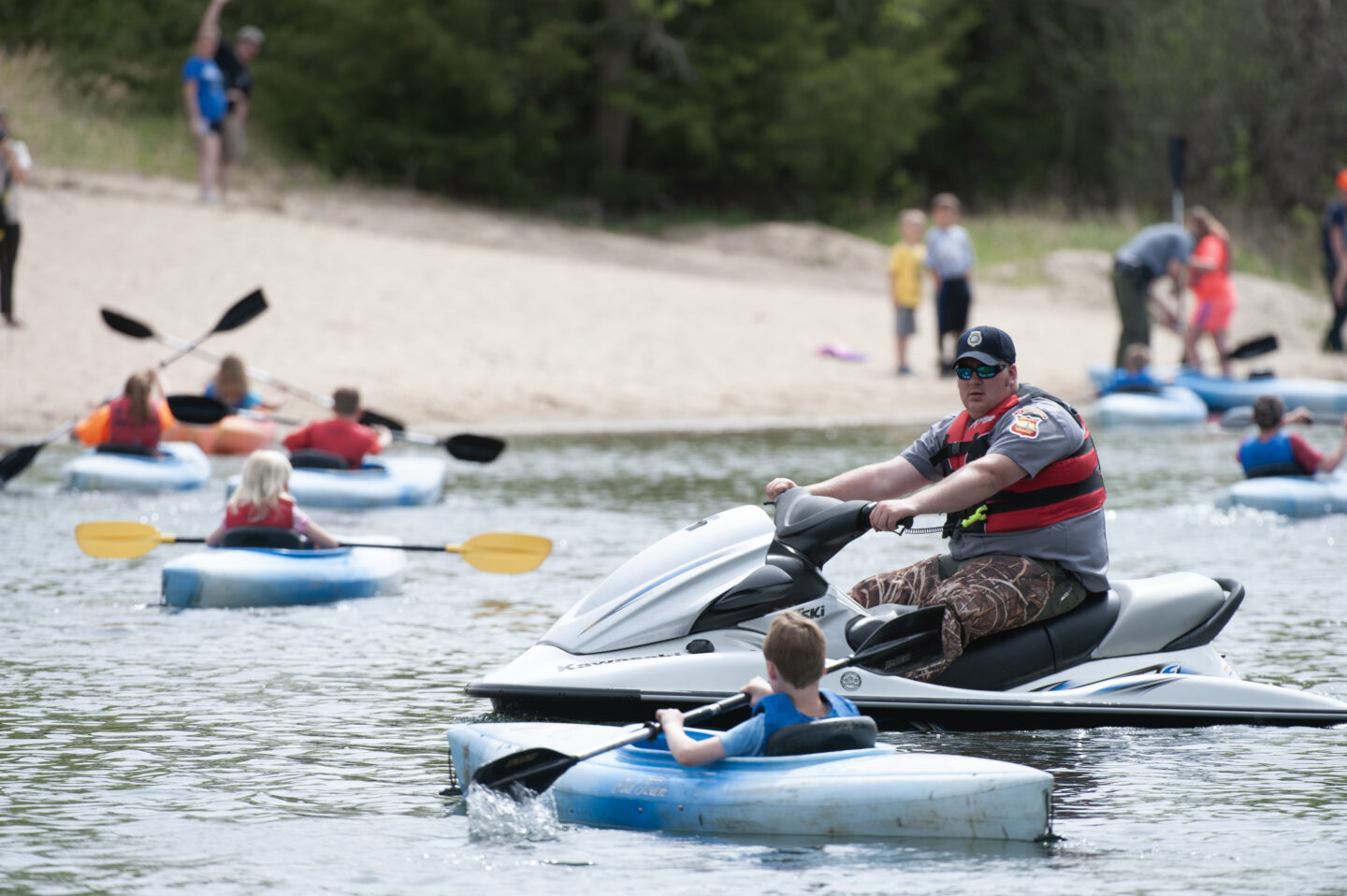 Commission Conservation Officer Bryce Streger patrols the lake in a PWC in the Kayaking exhibit at the Outdoor Discovery Program at Kearny State Recreation Area in Kearney County. Fowler, May 10, 2014. Copyright NEBRASKAland Magazine, Nebraska Game and Parks Commission.at the Outdoor Discovery Program at Kearny State Recreation Area in Kearney County. Fowler, May 10, 2014. Copyright NEBRASKAland Magazine, Nebraska Game and Parks Commission.