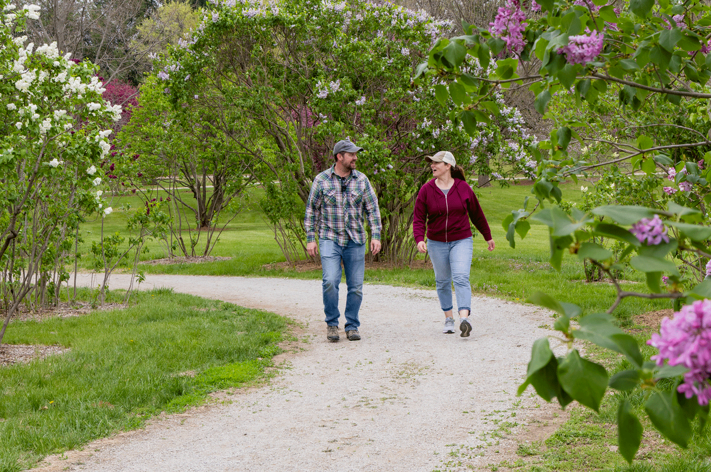 A man and woman walk along a road