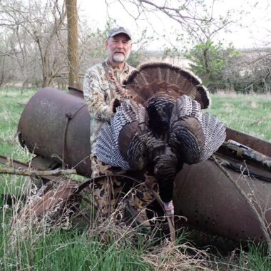 Hunter posing with spring gobbler. Photo by Daryl Bauer, Nebraska Game & Parks Commission.