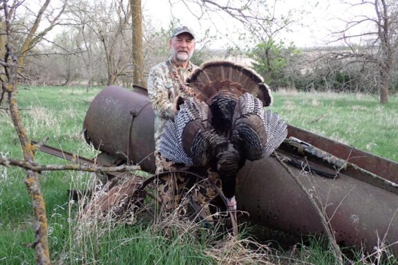 Hunter posing with spring gobbler. Photo by Daryl Bauer, Nebraska Game & Parks Commission.