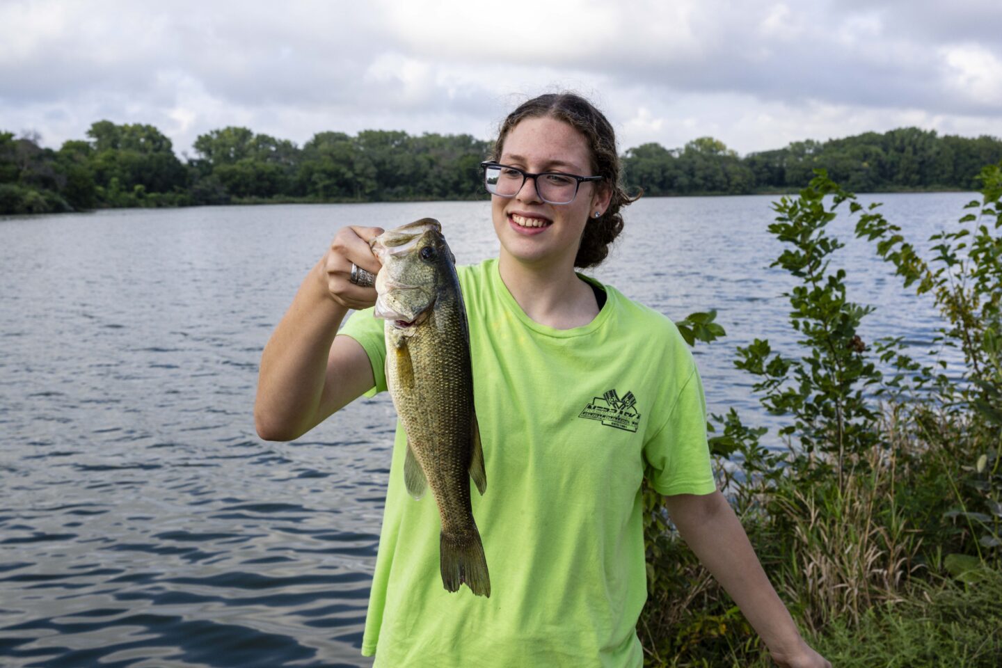 Brylee Eyer of Jansen holds a largemouth bass she caught while fishing on Lake 2.