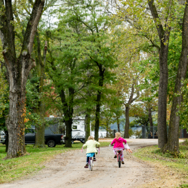 After visiting the playground, girls ride their bikes back to their campsite at Alexandria State Recreation Area.