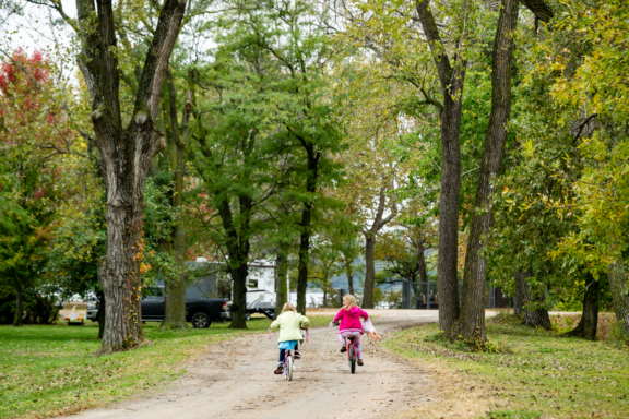 After visiting the playground, girls ride their bikes back to their campsite at Alexandria State Recreation Area.