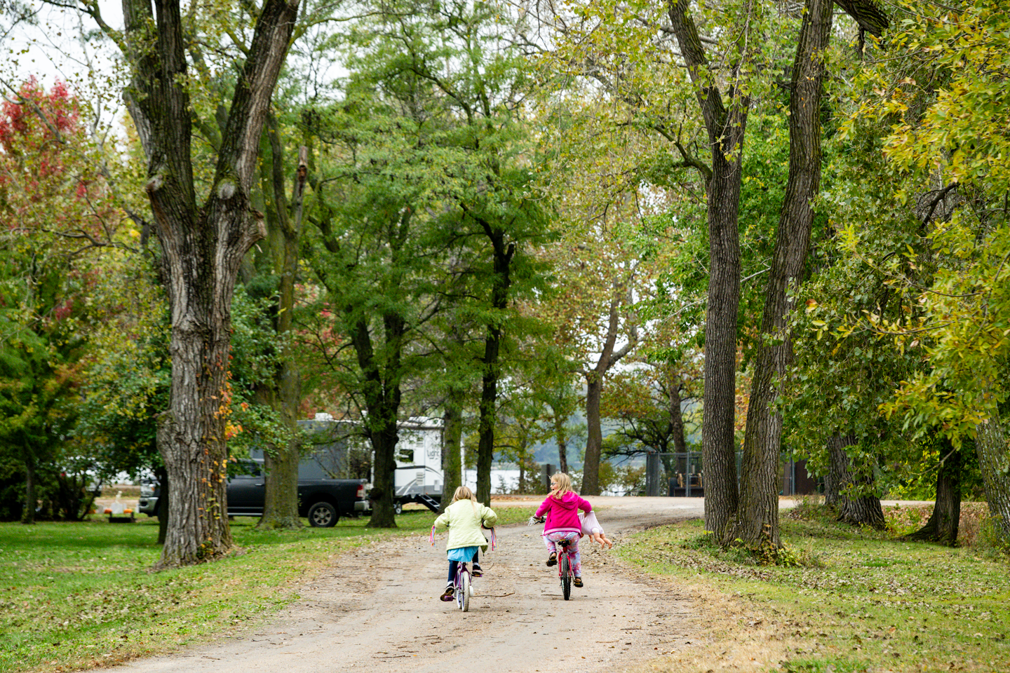 After visiting the playground, girls ride their bikes back to their campsite at Alexandria State Recreation Area.