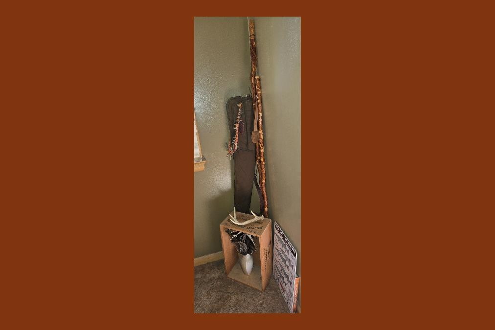 Walking stick, gun case, shed antler and turkey feathers, and muskie sign decorating corner. Photo by Daryl Bauer, Nebraska Game & Parks Commission.