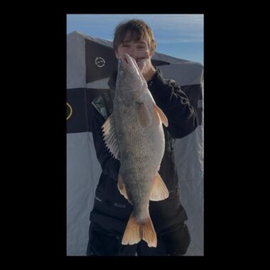 Ice angler holding saugeye. Photo submitted for state record cerification, Nebraska Game & Parks Commission.