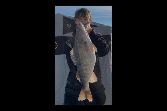 Ice angler holding saugeye. Photo submitted for state record cerification, Nebraska Game & Parks Commission.