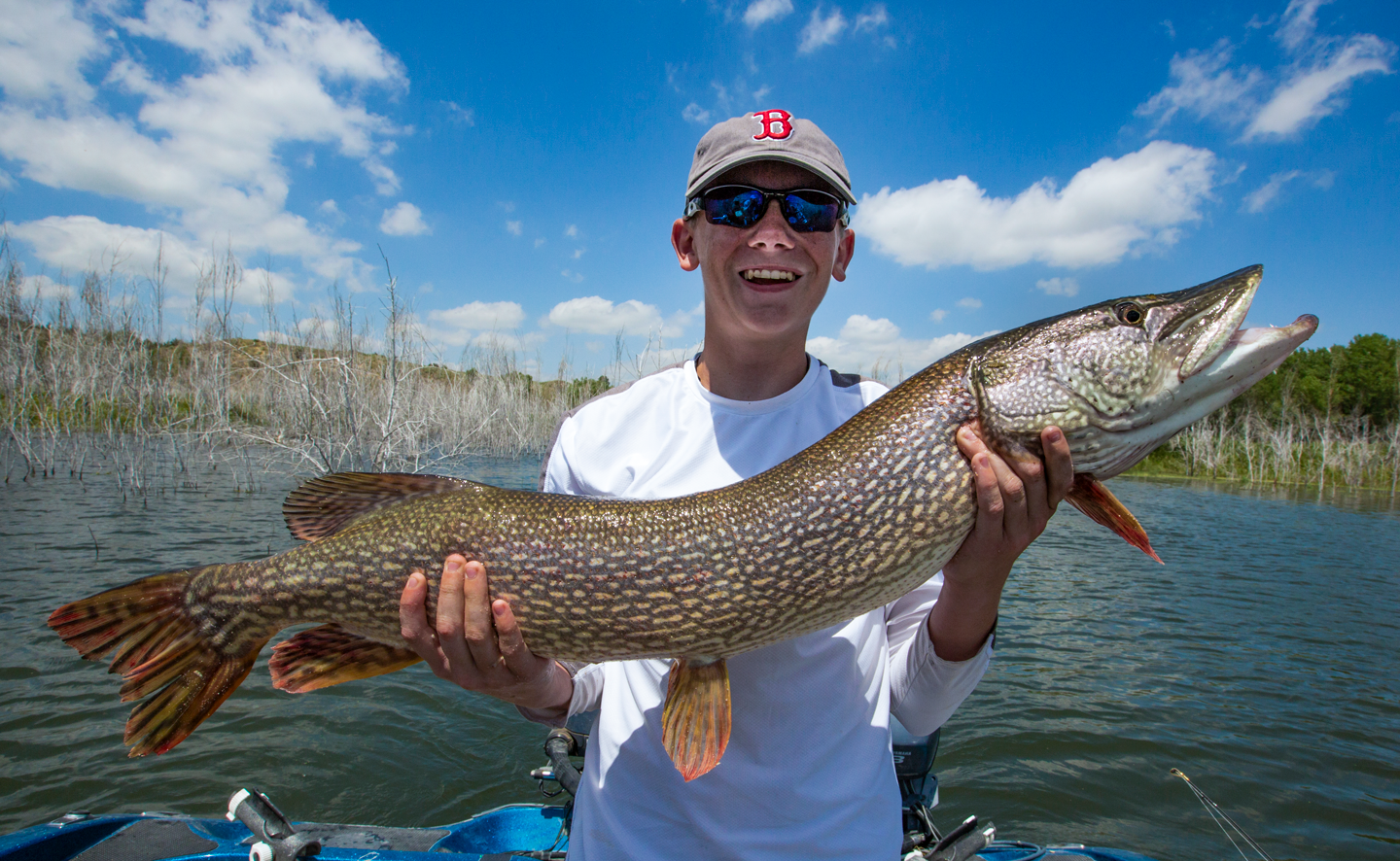 Blake smiles with a big northern pike.