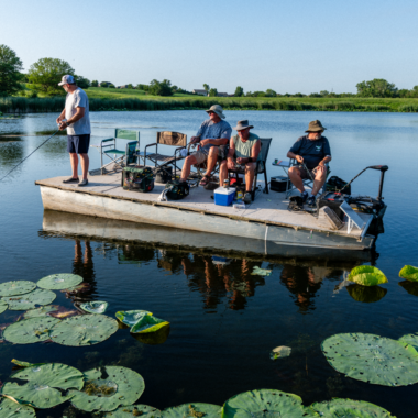 A group of men fishing from a boat.