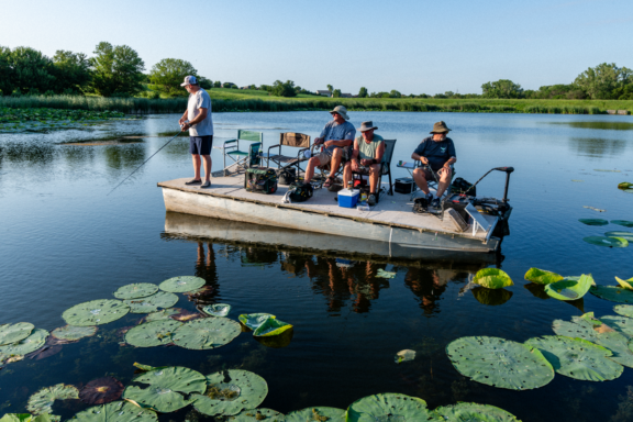 A group of men fishing from a boat.
