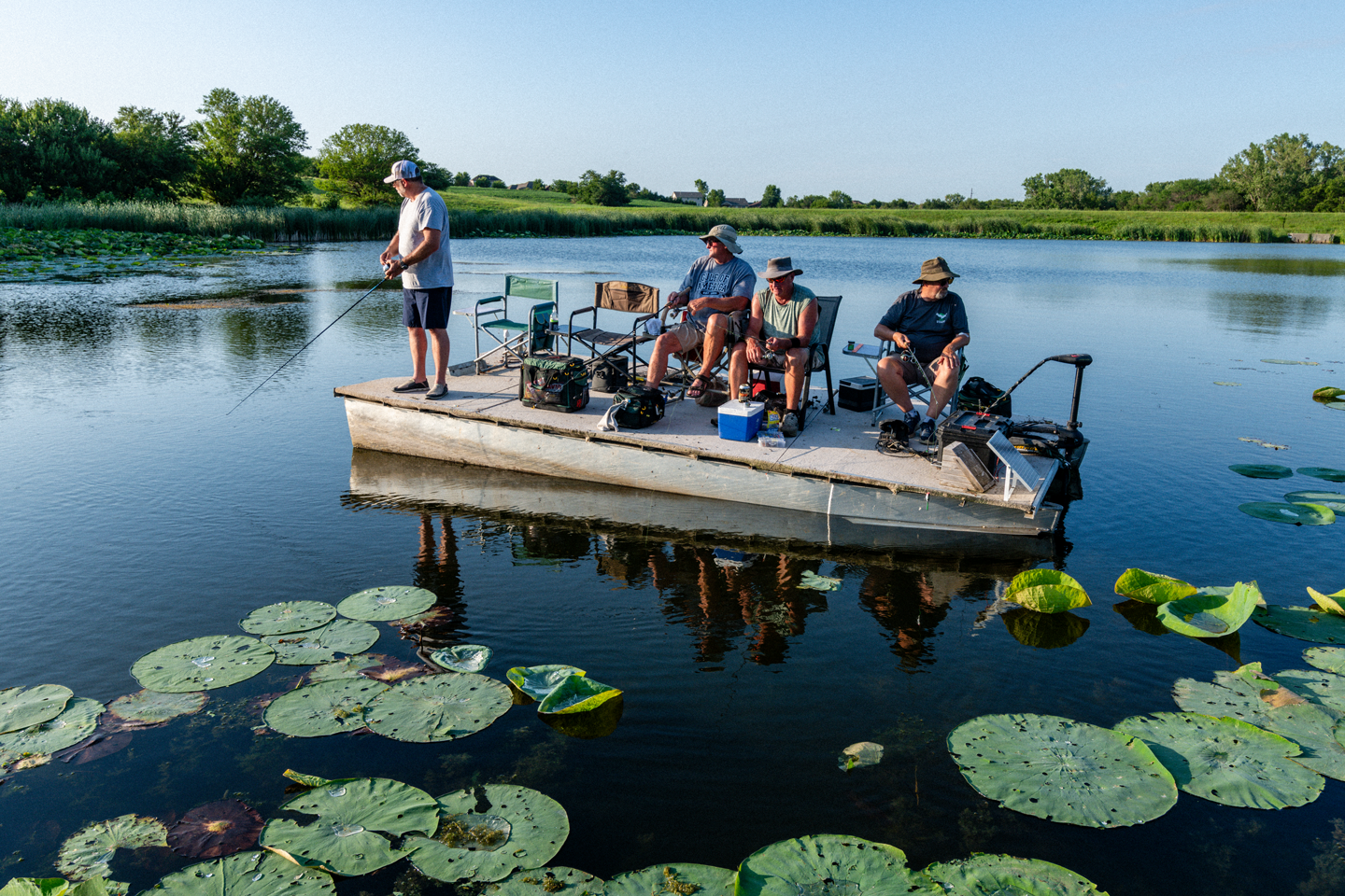 A group of men fishing from a boat.