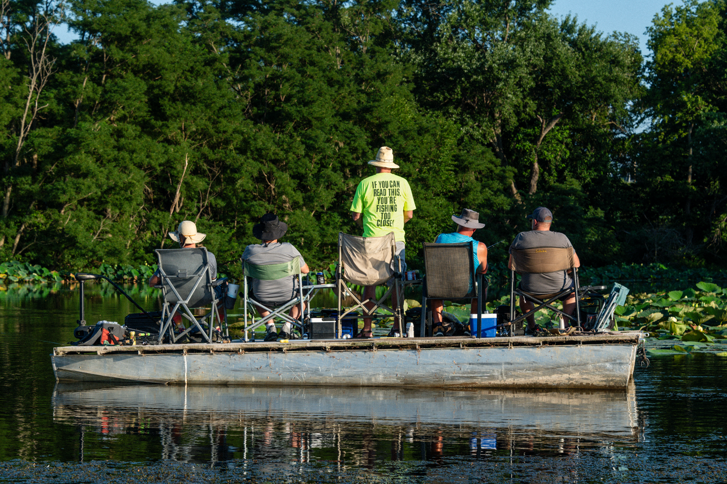 A group of men fishing from a boat.