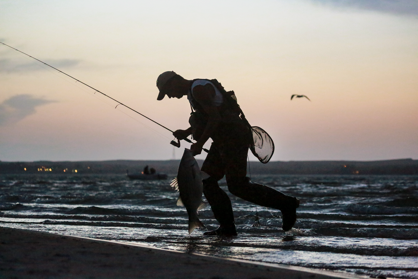 Scott McGuire of Grant hauls in a wiper right before a storm hits.