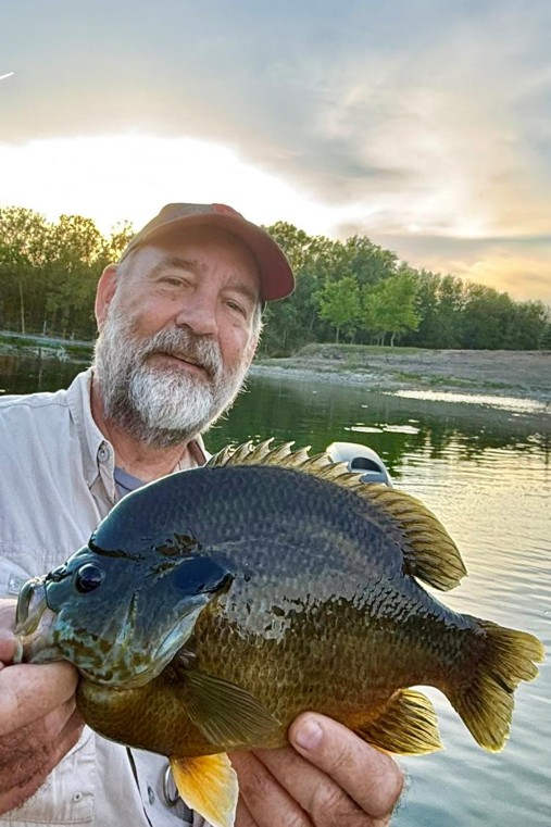 Angler holding a hybrid sunfish.