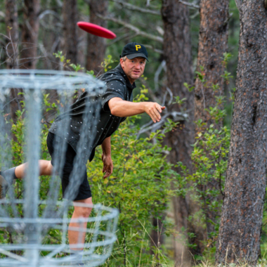 Zane Hesting watches his disc fly to the basket at Chadron State Park.